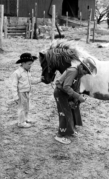 Billy McCaskill (right), age 9, manicures his Shetland pony Bootsie for the Madison Saddle Club Show as "Tootie" McCaskill, age 4, looking on at the McCaskill Azur Arab Horse Ranch.