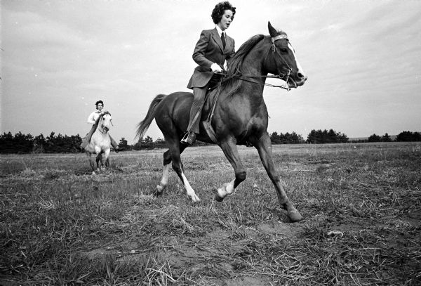 Two McCaskill girls, two styles of riding — Sandy, left, riding Western on her Arabian stallion, Tiraffle, and Sherry, right, riding her three-gated "Arab," Urfraffle, in the English style.