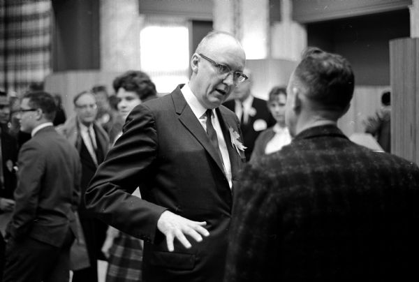 President Harrington shaking hands and greeting parents, friends, and students at the informal reception for the newly inaugurated University of Wisconsin President Fred H. Harrington. The event was held in the Memorial Union lounge.