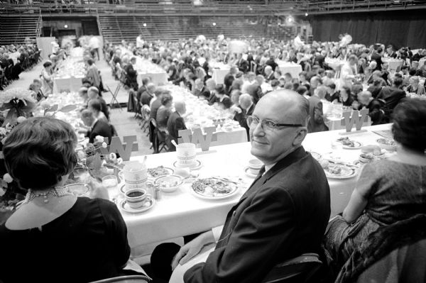 The Inaugural Banquet for the newly inaugurated President of the University of Wisconsin, Fred H. Harrington, was held at the Field House. Operating with scientific precision with instructions coming from a control tower in the balcony, a crew of about 100 waiters served 1500 dinners in ten minutes. The newly inaugurated University of Wisconsin President Fred H. Harrington is shown at the Inaugural Banquet.