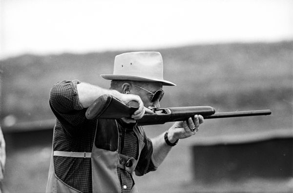 M.S. Ewlsworth, Caledonia, Illinois, blowing on his rifle after shooting it during a tournament sponsored by the Wisconsin Trapshooters Association.
