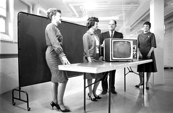 Members of the Madison City council of Epsilon Sigma Alpha presenting a television set to the Central Wisconsin Colony and Training School. Left to right: Mary Ann Usiding; Elaine Anderson, the group's president; Harvey Stevens, superintendent of Central Colony; and Lillian Grebel.