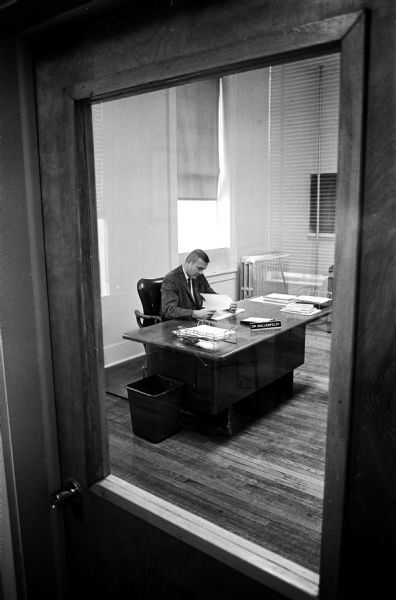 Milton College President, Dr. Evert Wallenfeldt, is shown at his desk in his simple, uncluttered office in Main Hall.