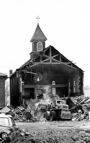 A bulldozer demolishing St. Joseph's Catholic Church at 10 South Park Street as part of the Triangle area urban renewal project.