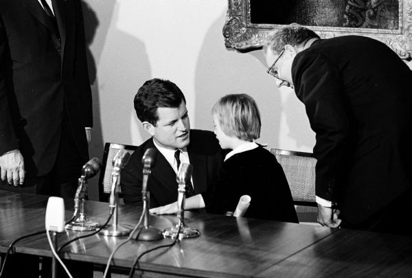 Sen. Edward Kennedy, left, chats with Betty Jane Martin, 6, who was representing Madison area mentally disabled children, as Gov. John Reynolds, right, leans in to listen. Kennedy and R. Sargent Shriver were in town C. The Kennedy Foundation contributed a $255,000 grant for the facilities. The National Institutes of Health and the Wisconsin Alumni Foundation also provided grants.