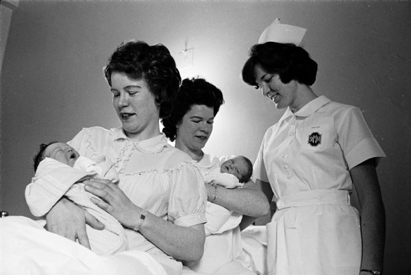 Two Waunakee sisters give birth to babies seven minutes apart at St. Mary's Hospital. Shown (L-R) are Mrs. Bruce Inkmann with her 9-pound boy; Mrs. Ray Carey with her 7-pound girl; and Miss Edna Ripp, the mothers' sister, a student at St. Mary's School of Nursing.