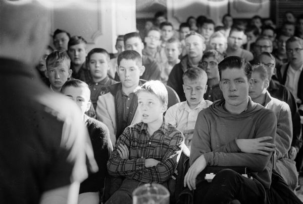 Wisconsin State Journal newspaper carriers listen to Vern Wiersma, 17 N. Butler Sreet, 1963 Young Columbus winner, explaining the Young Columbus contest for carriers. The winner receives a 12 day expense paid trip to Italy during Easter vacation.