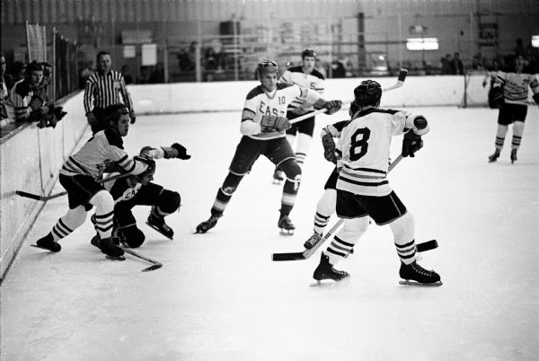 Action shot of the game where Madison East scored two goals to defeat defending hockey champion Central, 3-2, at the Madison Ice Arena. 
East had a 4-0 city record and 6-0-2 for the season, and put in 26 goals and allowed just nine. They won the city series title.