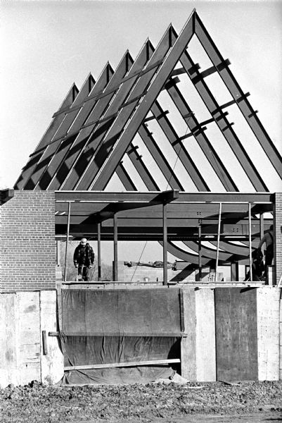 The framework of the new East Side Evangelical Lutheran Church at 2310 Independence Lane in process of being built. One construction worker is shown at work.