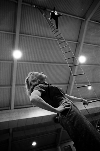 Mary Lou Lawrence, an aerialist for the William Kay Shrine Circus, watches as aerialist Sandy Winters practices before the opening of the circus sponsored by the Zor Temple of Madison. She was critically injured the year before when the circus performed in Madison.