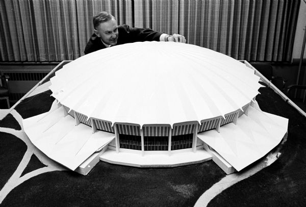 Architect James T. Potter is shown displaying a model of the proposed Dane County Coliseum.