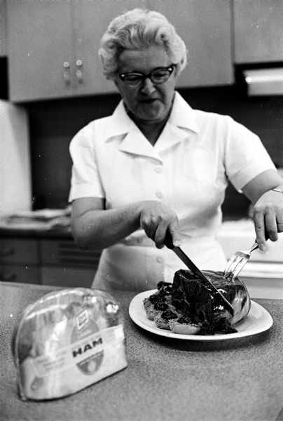 Rose Kepler demonstrates how easy it is to cut a boneless ham developed in Oscar Mayer's test kitchens in Madison.