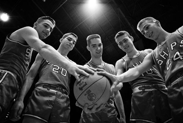 The Manitowoc High School boys basketball team starting five gather prior to their first state tournament game. Shown (L-R) are Kramer, Sullivan, Buerstatte, Jansson, and Ploederl. First names are not available.