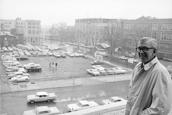Morgan Manchester, shown standing atop his present store with his recently purchased site of the former Christ Presbyterian Church visible across the street.