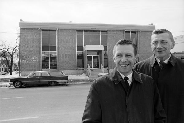 Sentry Insurance Co. managers are shown in front of their new building, 32 Proudfit St.,the first business to open in the Brittingham redevelopment project. At left is office manager E. W. Schmidt.  At his right is E. H. Lemmenes, branch manager.