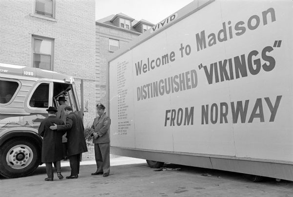 A Scandinavian trade delegation of 25 Norwegian businessmen and journalists visit Madison to publicize the inaugural flight of Scandinavian Airlines System (SAS) direct service from Copenhagen to Chicago. Erik Himle is shown ushering fellow Norwegians onto a sight-seeing bus at the Edgewater Hotel on Wisconsin Avenue.