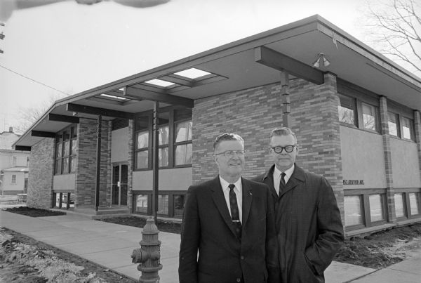 Dr. Carl A. Fosmark, left, and Dr. Chester A. Gjertson pose in front of the new ultra-modern health center at 2453 Atwood Avenue. It will house two physicians and three dentists.