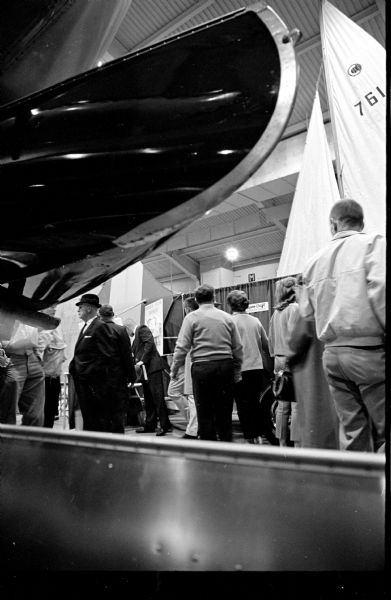 Spectators viewing different types of boats during the Madison Sports-Boat-Vacation show's opening night at the County Fairground.