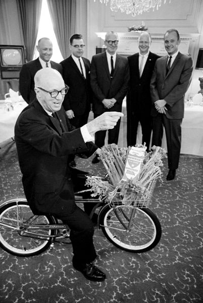 Duane Bowman is riding a small bicycle with a celery crop and a carton of milk in the basket, telling the 50th anniversary story of the start and growth of the Bowman Dairy. Standing in the background, left to right are Bowman relatives: James Peterson, sales manager; Al Jindra, advertising and sales; Don Morrissy, general sales manager; Albert Palmiter, production manager; and Duane Bowman, Jr.

Article by Robert Bjorklund about this event is also copies and included.