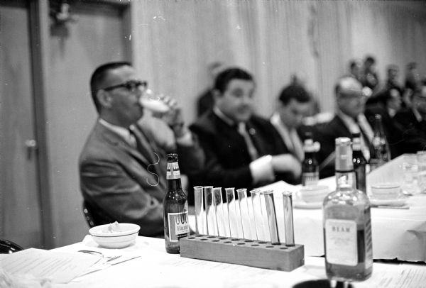 James Cowan drinking beer in preparation for a demonstration of police breathylizer tests and reactions of alcohol on potential drivers. The test program was conducted by the Madison Federal Safety Council, the Wisconsin State Patrol, and the Wisconsin Council of Safety.