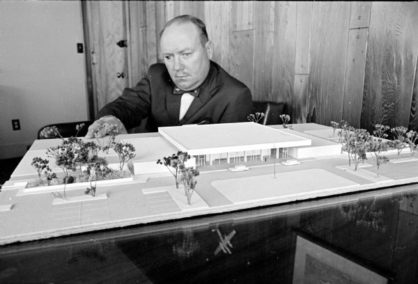 Airport Supt. Robert Skuldt is shown with a model of the new airport terminal to be constructed.