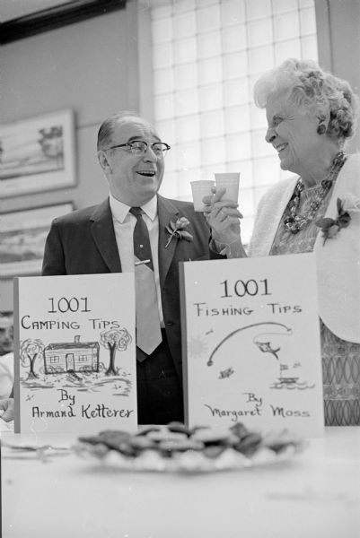 Armand Ketterer, supervisor of textbooks for the Madison public schools (left) and Margaret Moss, school librarian, discuss their plans for their future leisure time at a retirement party held in their honor at the Board of Education building, 351 West Wilson Street.