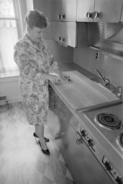 Mrs. Helen Renk, Rt. 2, Sun Prairie, Wisconsin, is shown in her kitchen. Mrs. Renk is submitting a favorite recipe for possible "election" into the Wisconsin State Journal Political Cook Book.