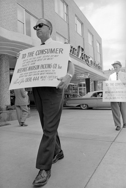 Striking members of Meat Cutters Union Local 444 employed at Neesvig's Packing Co. picketing in front of the Park Motor Inn, a customer of the meat processing firm. The strikers at the Park Motor Inn were headed by Charles F. Zalesak, union business representative. The picketing is designed to inform the public of the labor dispute and not to halt deliveries to the restaurants which are using Neesvig's products.