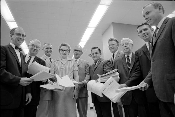 Democratic candidates file nomination papers for Dane County positions. Left to right are Otto Festge for county clerk; Harold Hill for register of deeds; Michael Torphy Jr. for district attorney; Jean Kirley for clerk of the Circuit Court; Vernon (Jack) Leslie for sheriff; Clyde Chamberlain for coroner; and George A. Weir for surveyor. Alex Ely, the present surveyor, is not running for reelection.