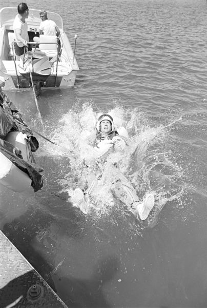 Truax Field pilots practicing water survival techniques in Lake Mendota near Warner Beach. The pilots, members of the 325 Fighter Interceptor Squadron, were hooked to a chair-like harness, dropped into the water and pulled backwards through the water by a speedboat to simulate the drag of an open parachute. Pilots were picked up by helicopters alerted by orange flares. The training is part of an overall Air Force program to improve survival of pilots when they parachute into open water.  