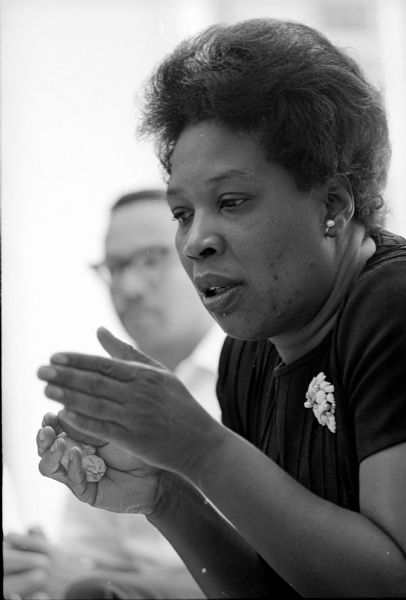 Alabama A and M College professor Dorothea Smith speaking at a press conference. She was one of 51 mathematics teachers from 40 predominantly Negro colleges who attended the University of Wisconsin's eight-week mathematics institute. Its purpose was 'to upgrade their teaching' and to 'discuss recent changes in mathematics.'