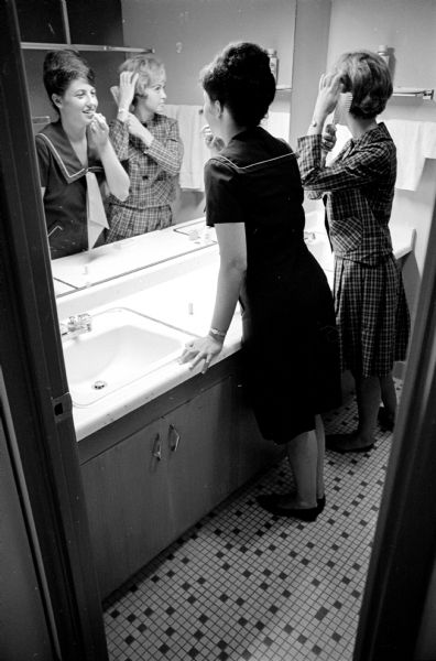 In one of a series of photographs showing the luxurious features of private dormitories on campus, Freddie Gross, Houston, Texas, left, and Wendy Smith, Green Lake, are shown in one of the bathrooms which serve four co-eds at Allen Hall, 505 North Frances Street.