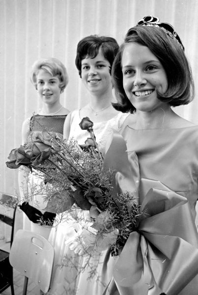 The West High School Homecoming Queen and her Court prepare to appear at the school's homecoming game versus Kenosha Bradford High School. Shown (L-R) are: Carol Olsen, 4312 Upland Drive; Marcia Welsh, 4317 Tokay Blvd; and Queen Susan Derse, 3547 Topping Road.