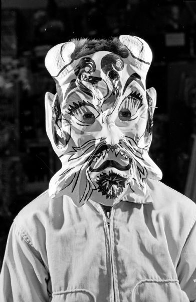 Portrait of Gene Hagen wearing a mask of a horned goblin.