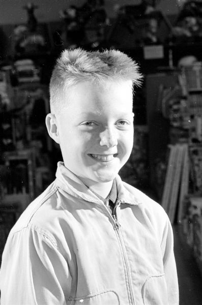 Portrait of a smiling Gene Hagen, age 10, without his masks, but with a crew-cut hair style.