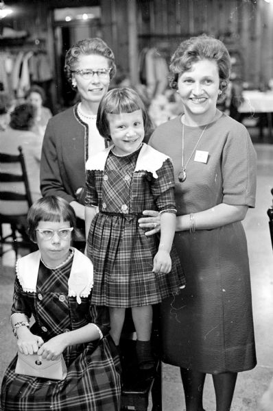 Two mother-daughter pairs pose at the Opti-Mrs. club mother-daughter luncheon at Kennedy Manor. Jill Reynoldson, age 9, is at left in the front with her mother, Virginia behind her. In the center is Anne Beyer, age 4, with her mother, Joan, on the right.