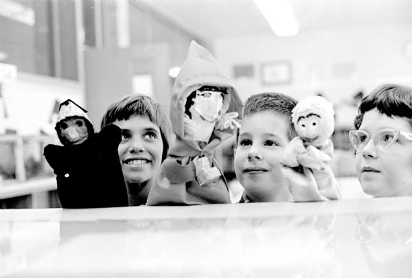 Three students from Orchard Ridge school displaying the puppets they made representing characters in books they had read. Left to right are: Lynette Franklin, Ross Thompson, and Christine Ralls.