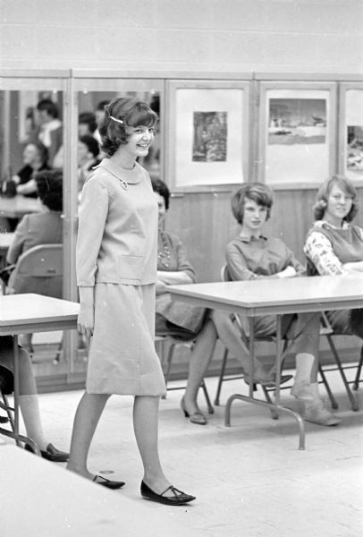 Students from the 9th grade home economics class at Van Hise Junior High School model for their parents and classmates at a homemade style show at the school. Shown modeling her two-piece blue dress is Ann Erdmann, daughter of Mr. and Mrs. Arden Erdmann, 4809 South Hill Drive.