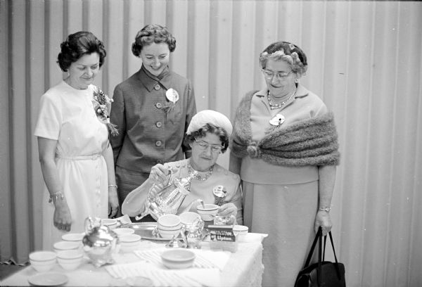 More than 1000 Dane County Homemakers were invited to the Annual Christmas Tea held recently in the Youth Building at the Dane County Fairgrounds. Left to right are: Mrs. Alma Statz, Waunakee; Mrs. Arthur Post, Mt. Horeb; Mrs. Erwin Barkhahn, Madison; and Mrs. E.R. Stoneman, Madison.
