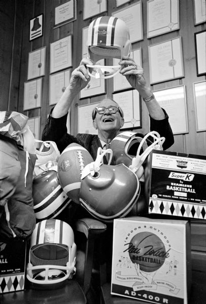 WSJ sports columnist, Roundy Coughlin, is shown admiring athletic equipment to be given to underprivileged children. It was provided by an anonymous donor.