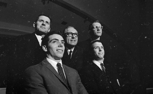 U.W. gymnasts who qualified for the NCAA tournament are shown before the annual banquet sponsored by Madison Turners and held at Turner Hall. Left to right: first row - Fred Roethlisberger and Bill Hoff. Second row - Pete Bauer, Coach George Bauer, and Jerry Herter.