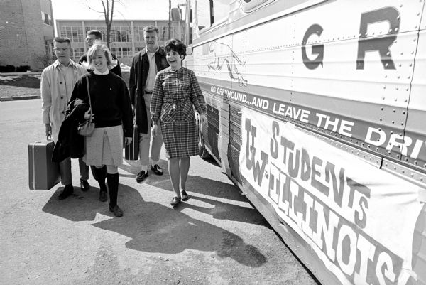 Five University of Wisconsin students boarding a bus for the University of Illinois with the first student exchange between the two Big 10 schools. 20 boys and 19 girls will exchange places with 39 of their counterparts at Illinois for the weekend.
In the picture are Mary Gjetson, Wausau, a junior, and Caroly Svetlik, Neillsville. Behind them are, from left, Richard Welland, Delavan, the social chairman of Conover House; and John Phillips and James Hoffman, both of Racine.