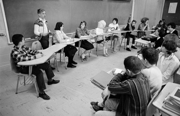 Bill Todd, 13, standing, is a student at Cherokee Heights School talking about proper dress during a debate in a seventh grade class. Other students in the picture were among ten who volunteered to appear in improper dress to add realism to the debate.