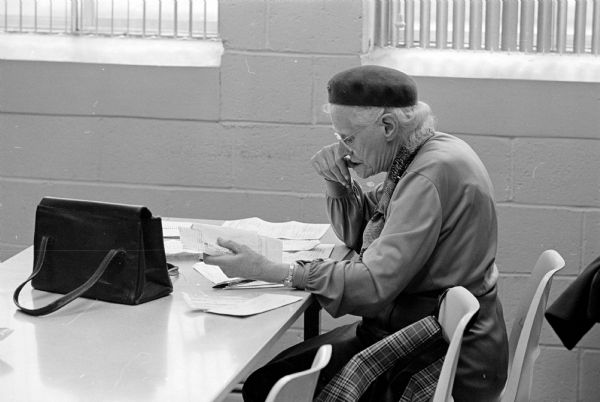 Income tax filer reading the small print on the forms at the Federal Tax Office on University Avenue.