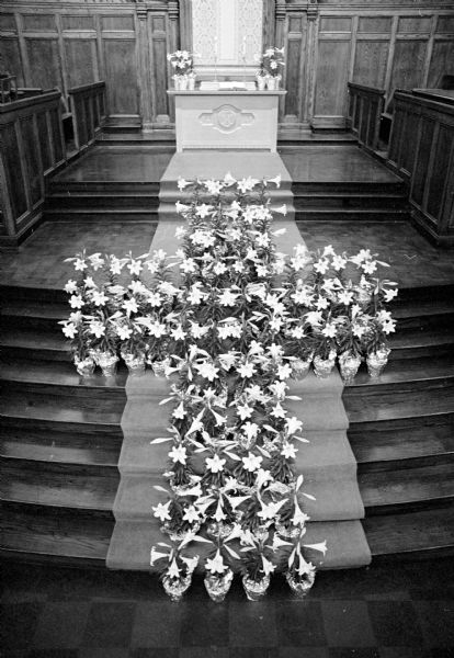 A cross of lilies, each lily representing a deceased person, commemorates the resurrection at First Congregational Church, 1609 University Avenue.