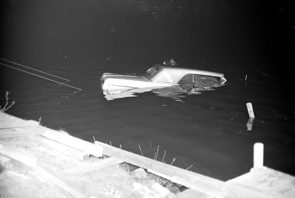 Miss Kris Natvig, 17, daughter of Mr. and Mrs. David A. Natvig, 902 W. Shore Drive, rescued Mrs. Clifford D. Kenison moments before her car sunk into Monona Bay in the 800 block of W. Shore Drive. Miss Natvig was assisted by Lauren Leighton, 30, 3128 Lakeland Avenue, and Douglas Miller, 41, 5005 Spaanem Aveune. Mrs. Kension, 829 S. Shore Drive, was charged with drunken driving.