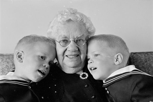 Twins Jonny & Billy Klahr, age 3, sons of Mr. and Mrs. James Klahr, McKee Road, give their great grandmother, Mrs. Minnie Hill, age 90, 206 Richland Lane, a big hug in anticipation of their common birthdays on May Day.
