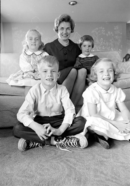 Mrs. Robert E. Fish, 300 Laurel Lane, is general chairman of the annual tea dance sponsored by the Rector's Guild of Grace Episcopal Church. Mrs. Fish is shown with her children, (seated on floor) Robbie, 6, and Betsy, 5, and (seated on couch) Sarah, 8, and Laura, 3.