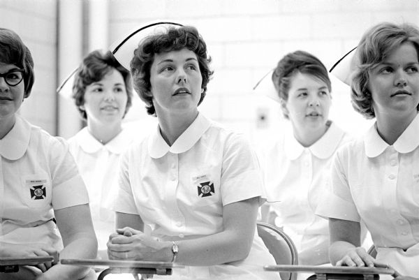 Donna Osness, third from right, listens to a lecture with classmates. Right to left: Helen Nassen, Lois Schneckloth, Lodi; and Nancy Schindler, New Glarus; One of a series of images about Donna, a mother of five children, who is participating in a new Madison General School of Nursing program for married women.