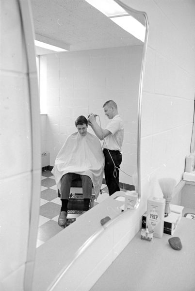 Seminarians at Holy Name Seminary give each other haircuts at the facility's barber shop. Gordon Hellenbrand, Cross Plains, is giving a haircut to Steve Merkel, Reedsburg.